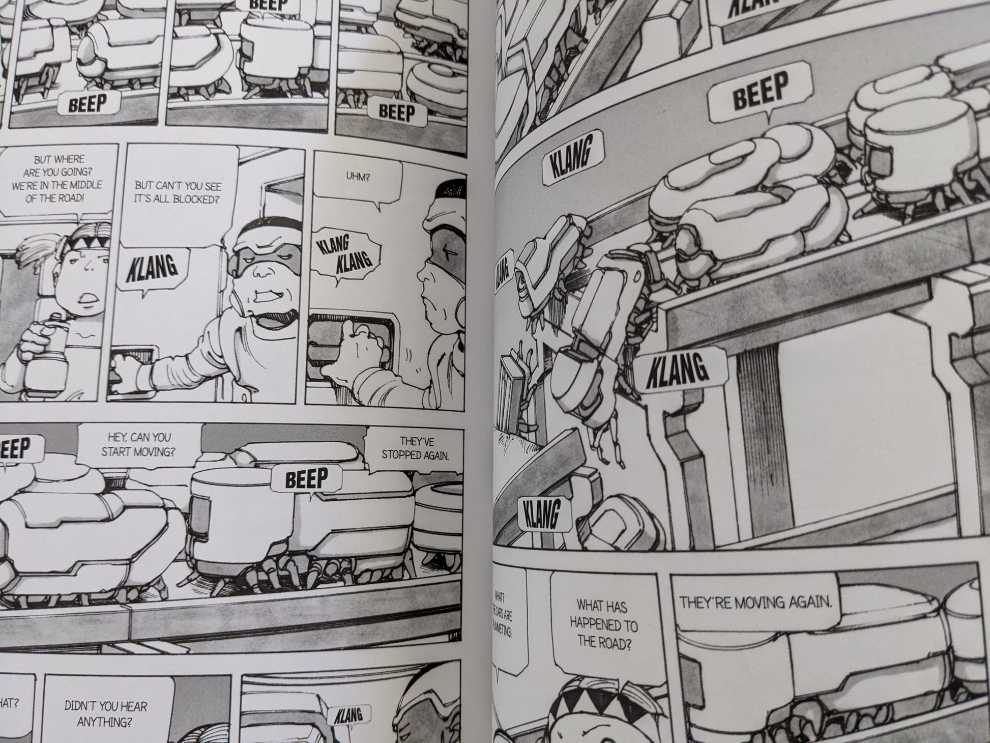Robot vehicles clogging the road in 'Parasitic City #2' as characters navigate traffic chaos.