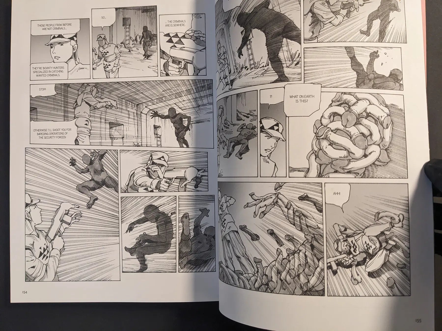 Interior spread showing security forces fighting intruders and a grotesque mass of bodies and limbs.