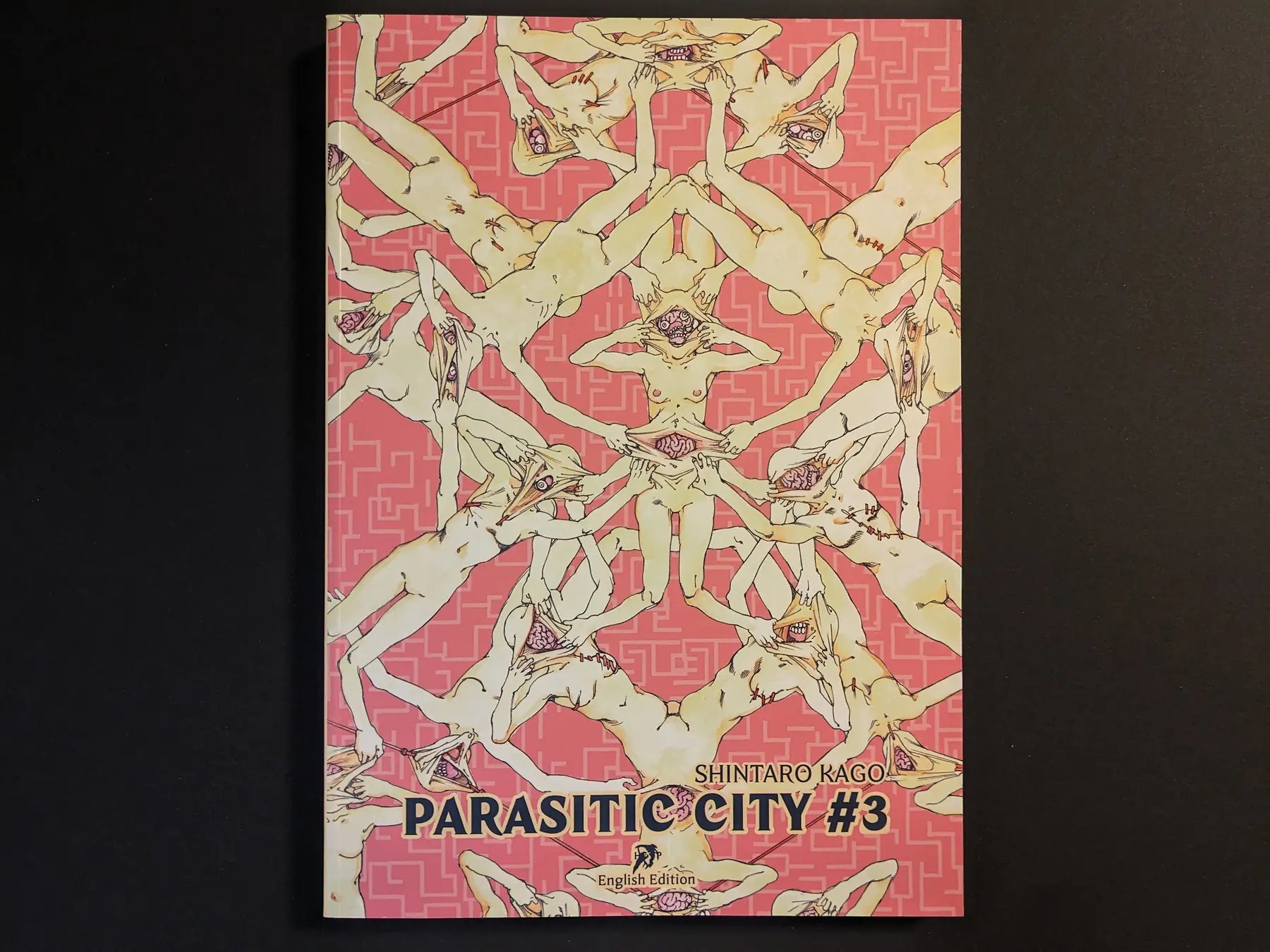 Front cover of “Parasitic City #3” English edition by Shintaro Kago with kaleidoscopic nude figures and pink maze pattern.