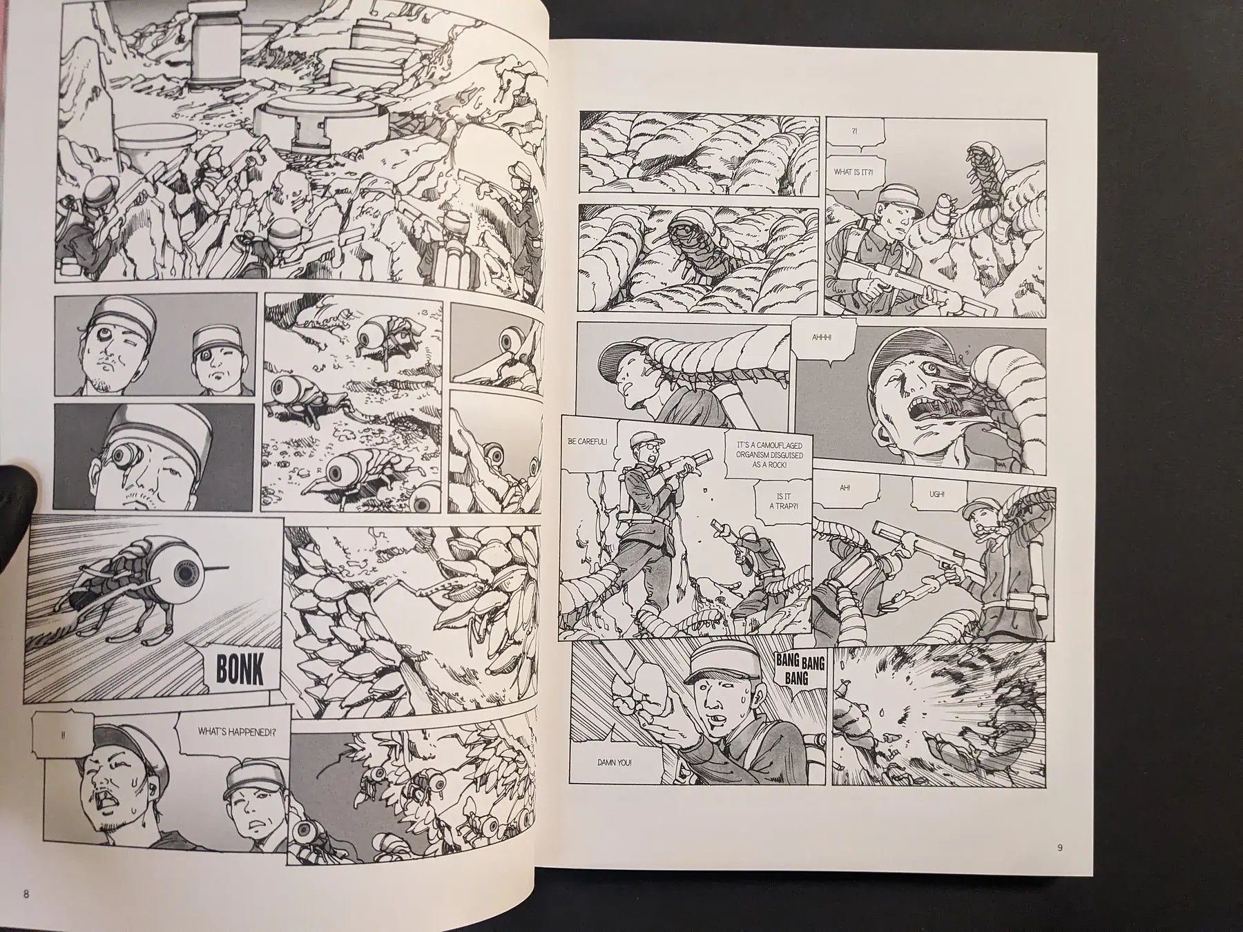 Interior spread from “Parasitic City #3” showing soldiers in a rocky landscape attacked by worm-like parasites in black-and-white manga panels.