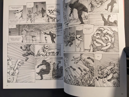 Interior spread from Parasitic City #3 showing security forces fighting intruders and a grotesque mass of bodies and limbs.