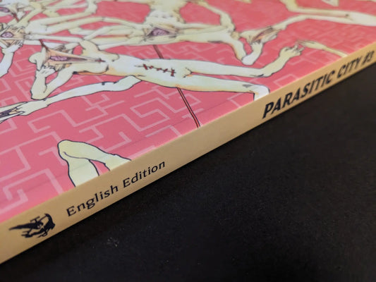 Spine of Parasitic City #3 English edition with the Hollow Press logo and title on a pink patterned cover.