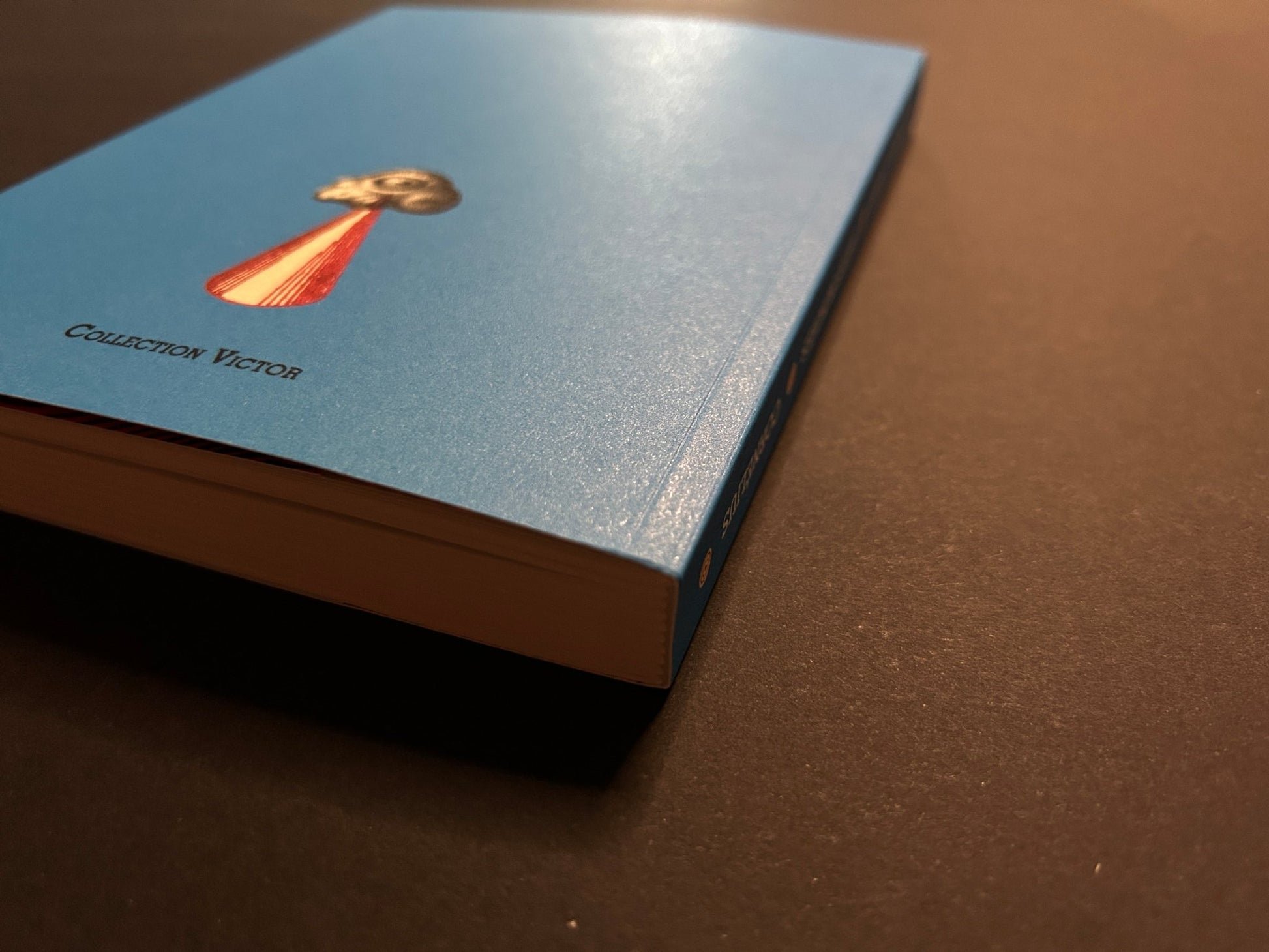 Pièces montées blue paperback shown at an angle, with the cover and page edges visible