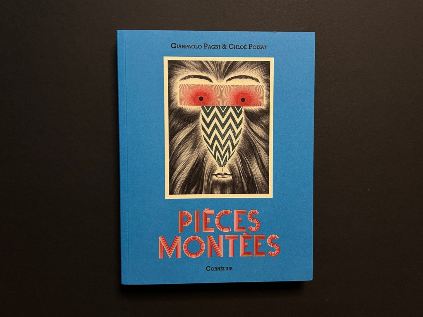 Pièces montées by Chloé Poizat and Gianpaolo Pagni, front cover on a blue paperback