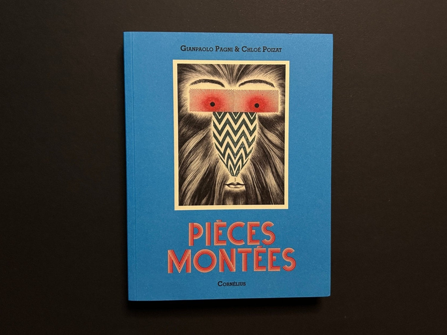 Pièces montées by Chloé Poizat and Gianpaolo Pagni, front cover on a blue paperback