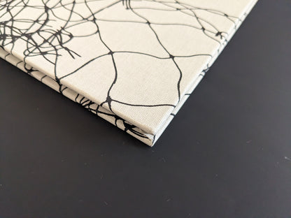Corner of the spine showing fabric wear on the hardcover binding of Pigeons by Stephen Gill