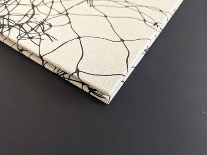 Corner of the spine with fabric wear on the hardcover binding of Pigeons by Stephen Gill.