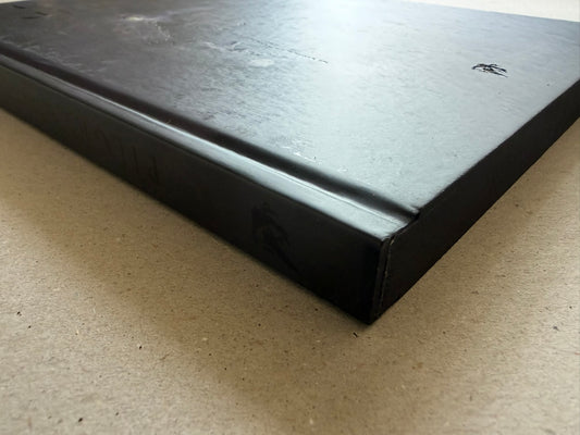 Close view of the black hardcover edge and debossed cover finish