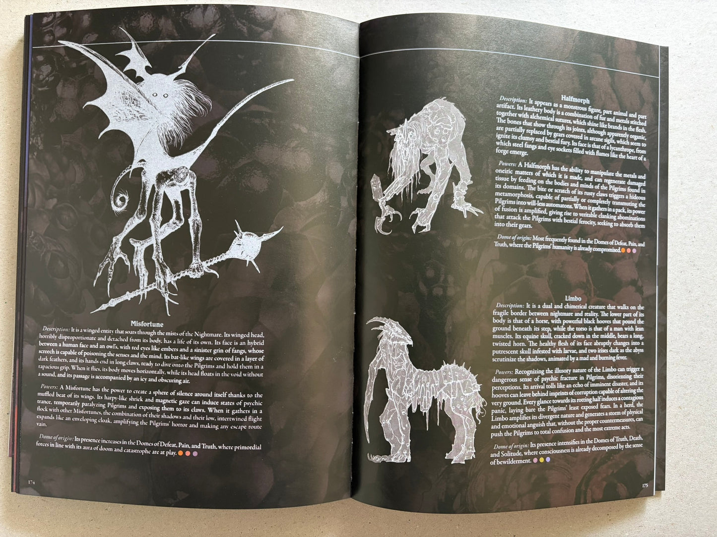 Open spread with Misfortune and Halfmorph illustrations on a dark background