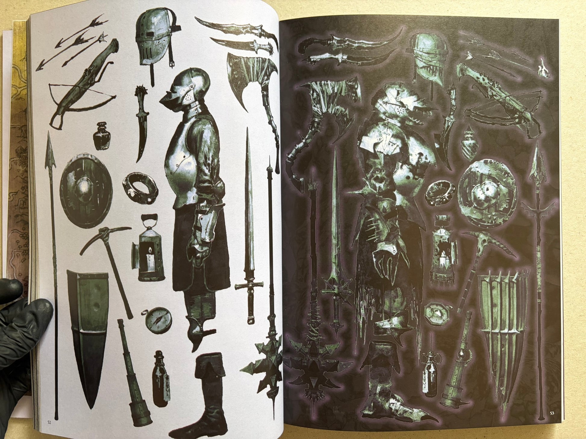 Two-page spread of weapons and armour sketches, with a gloved hand holding the book