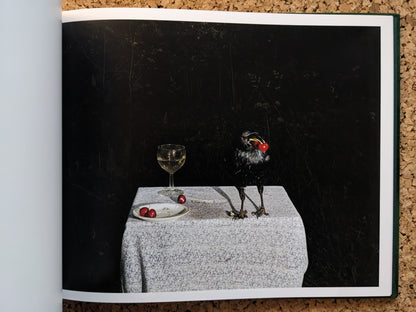 Interior spread from Plates I-XXXI, black bird holding a cherry beside a wine glass and a plate with cherries.