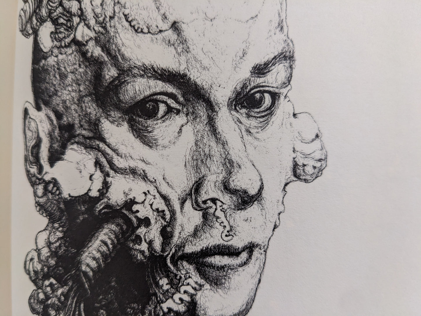 Close-up of a human face with biomechanical growths along one side.