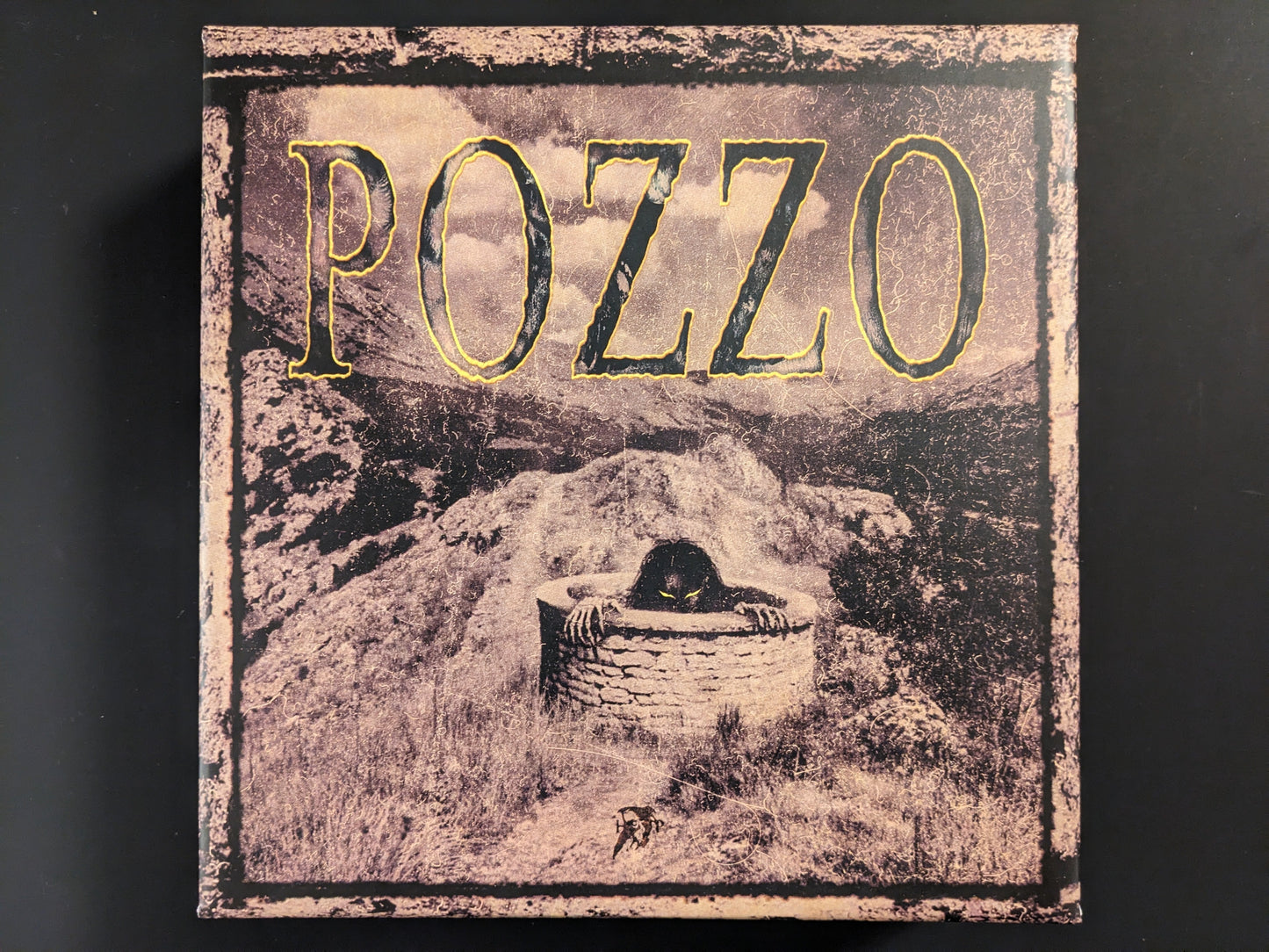 Front view of the POZZO board game box by Hollow Press with dark horror-themed artwork.