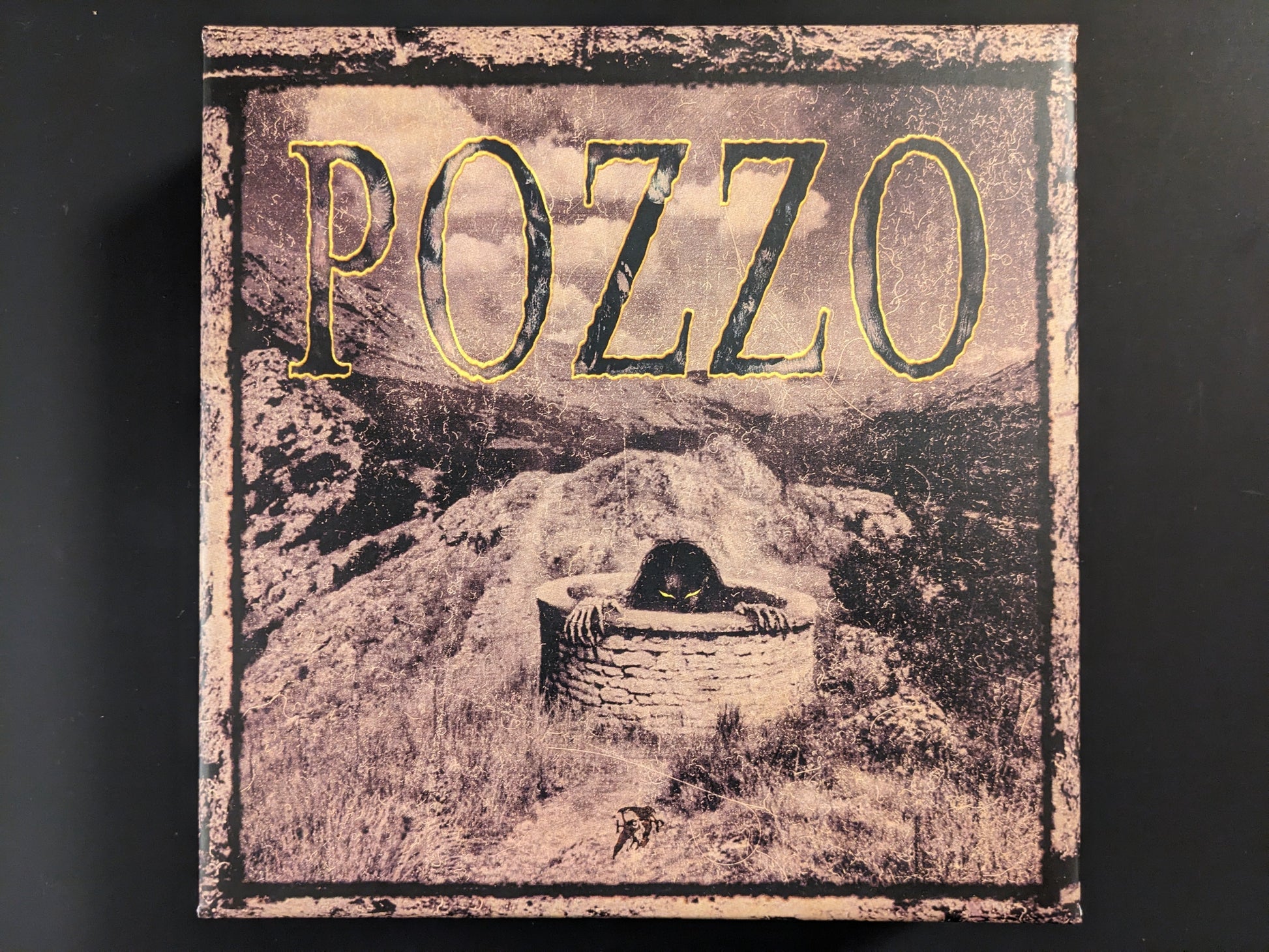 Front view of the POZZO board game box by Hollow Press with dark horror-themed artwork.