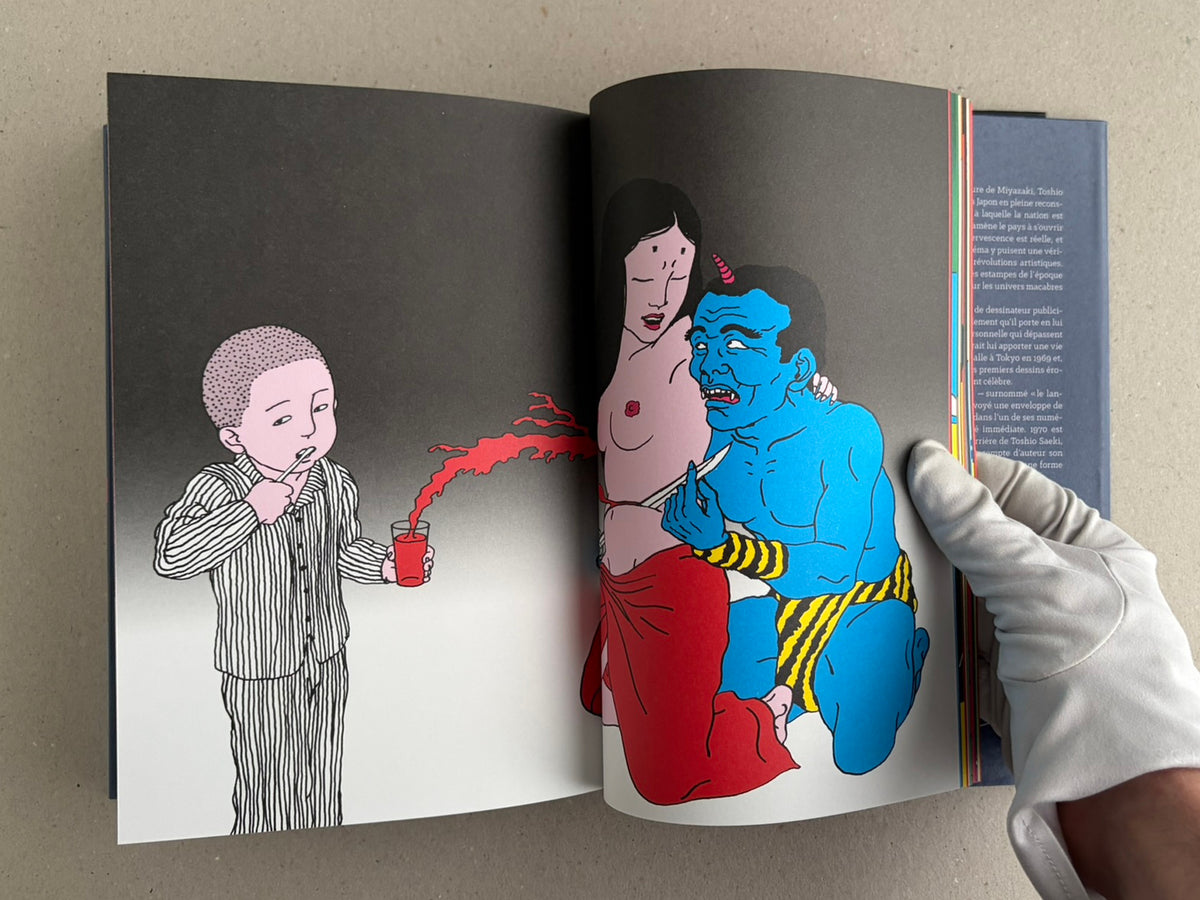Rêve écarlate by Toshio Saeki open to a black-and-white spread with a red drink and a blue figure on the right.