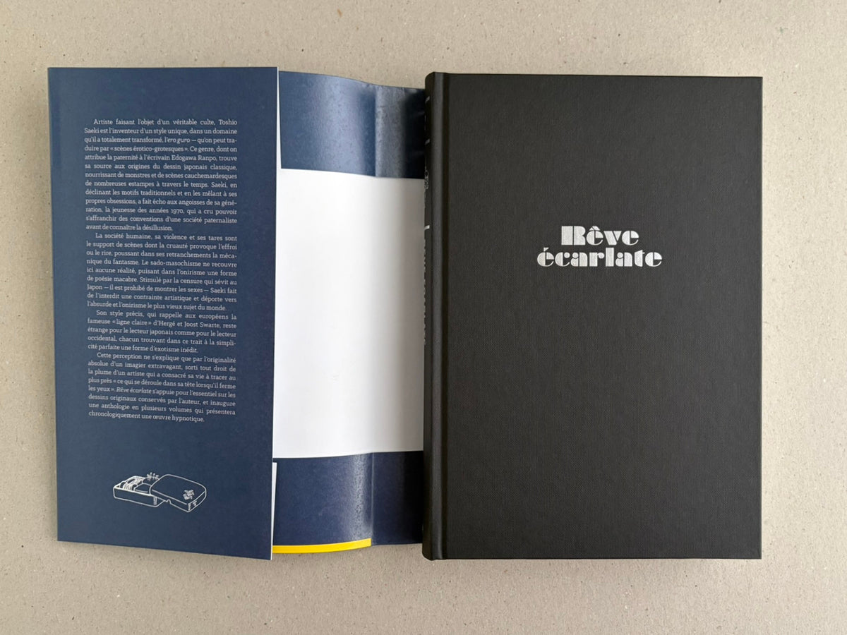 Rêve écarlate by Toshio Saeki opened to the dust jacket flap and the black hardcover with the title on the front.