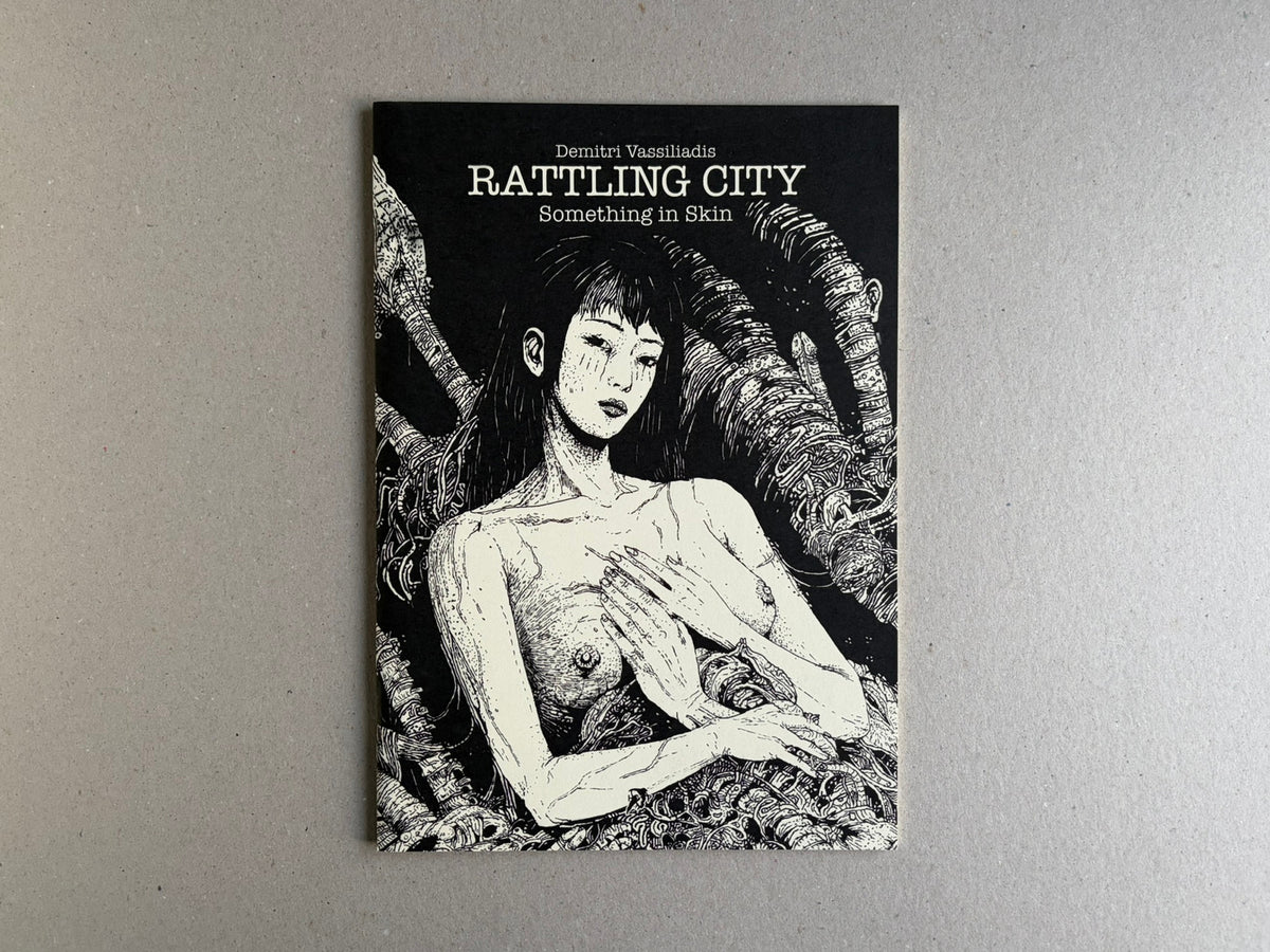 Cover of Rattling City #1: Something in Skin by Demitri Vassiliadis, showing a black-and-white illustrated figure on a black background.