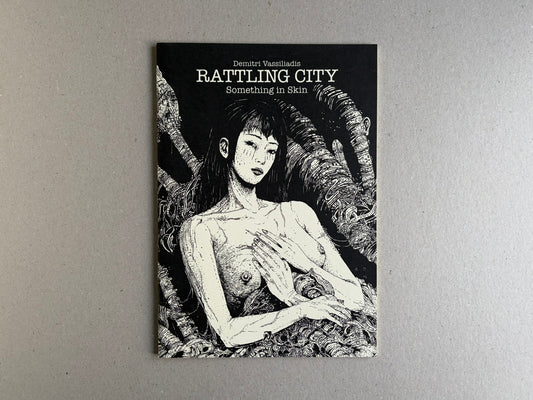 Cover of Rattling City #1: Something in Skin by Demitri Vassiliadis, showing a black-and-white illustrated figure on a black background.