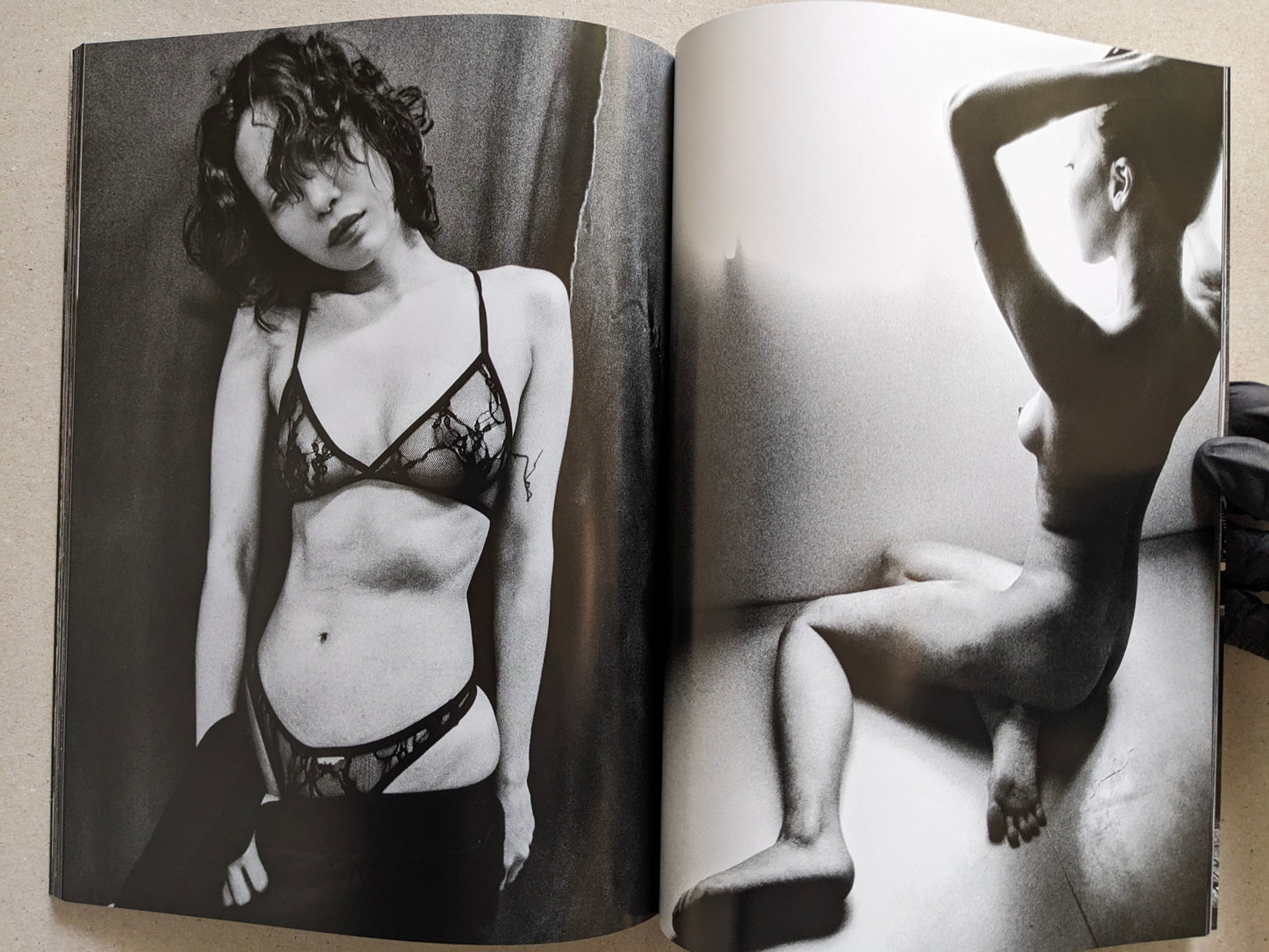 Spread with a studio portrait in lingerie and a nude figure in a bathtub, Record No. 50 by Daido Moriyama.