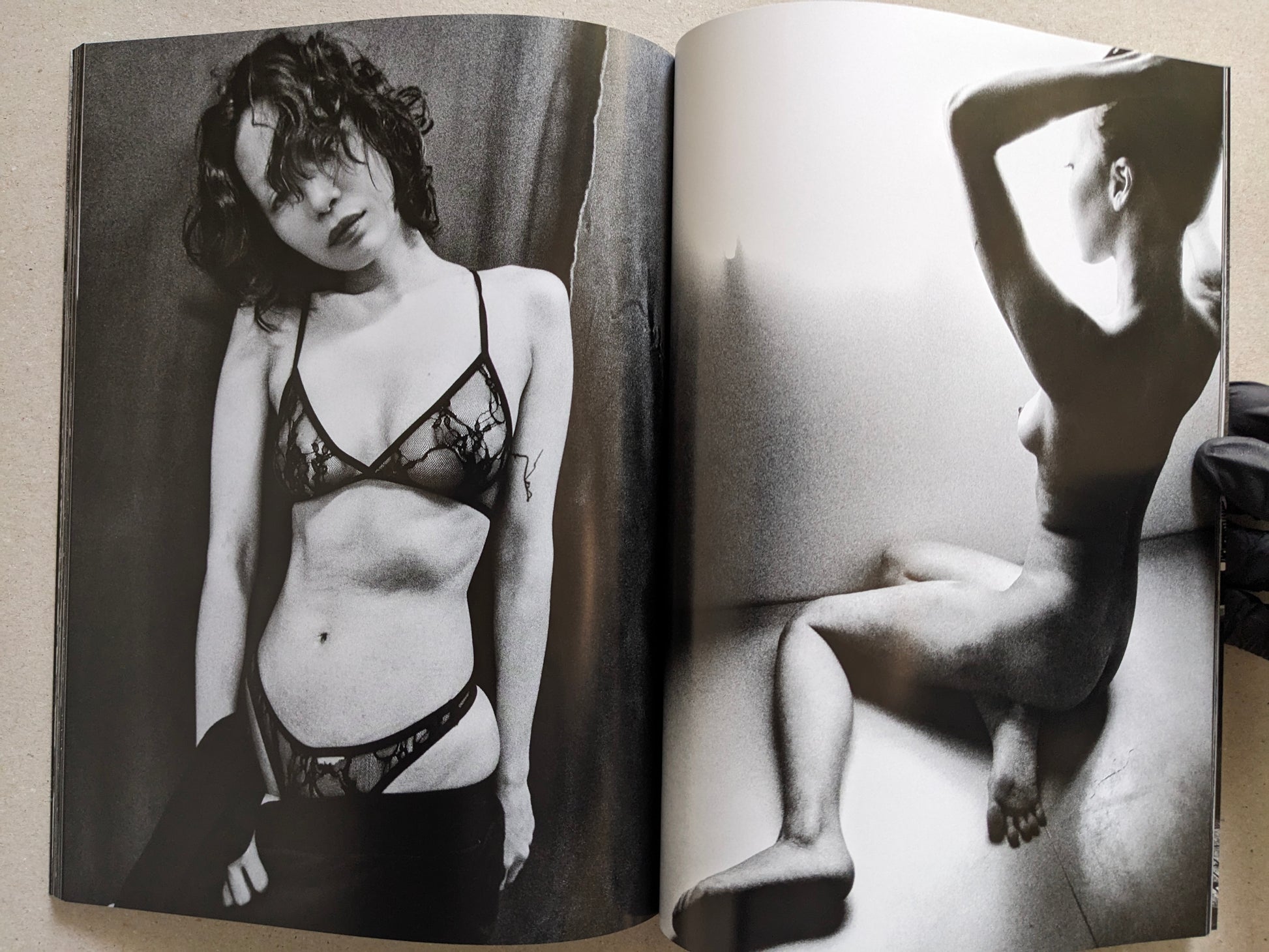 Spread with a studio portrait in lingerie and a nude figure in a bathtub, Record No. 50 by Daido Moriyama.