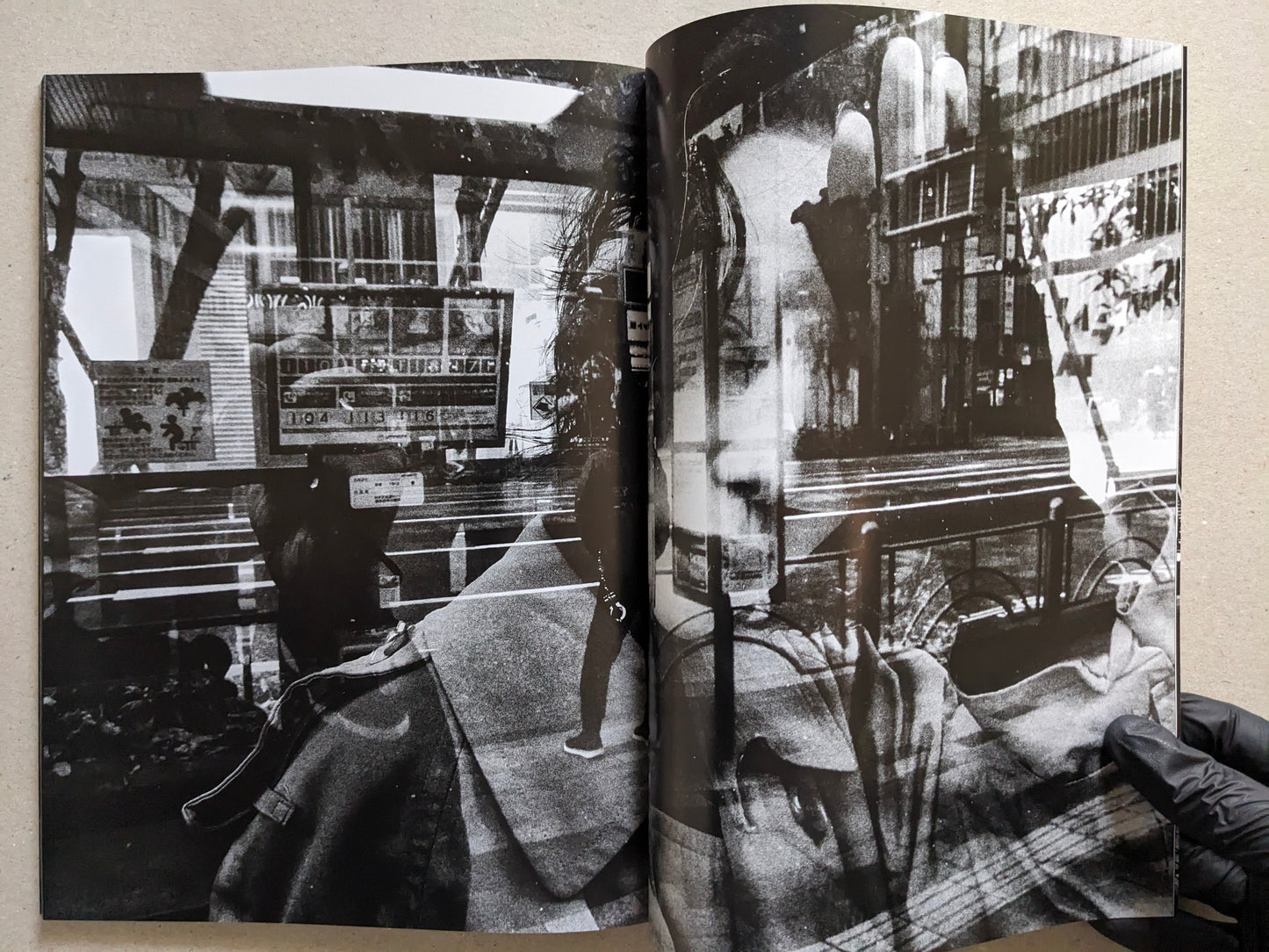 Double-exposure spread combining street signage and a close-up portrait, Record No. 50 by Daido Moriyama.