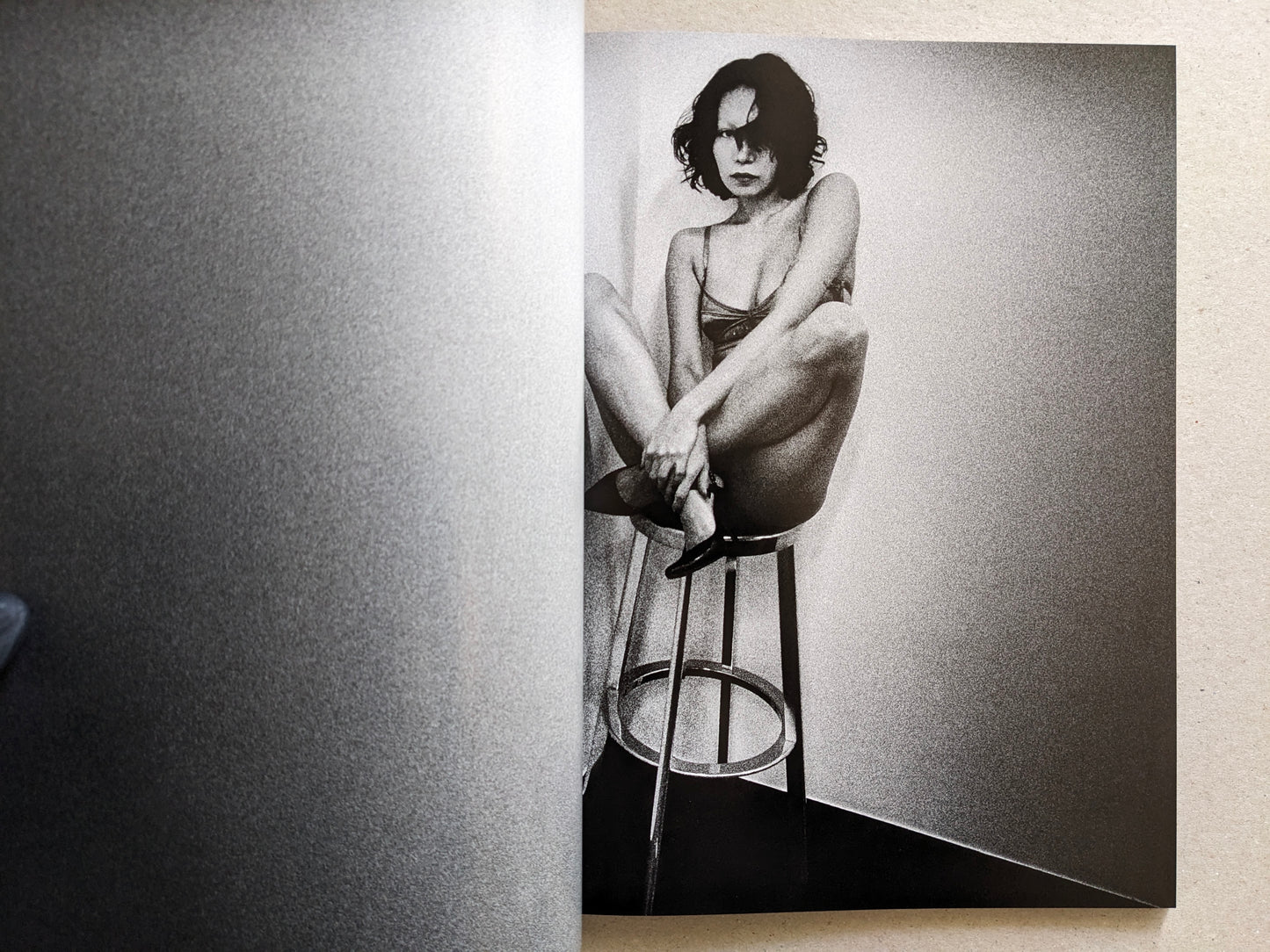 Studio portrait of a woman seated on a stool, Record No. 50 by Daido Moriyama.