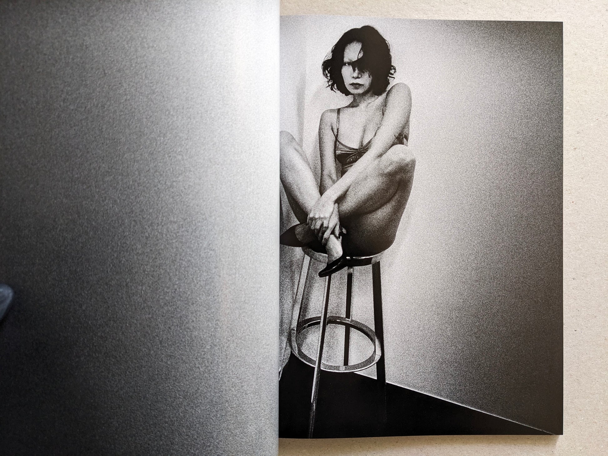 Studio portrait of a woman seated on a stool, Record No. 50 by Daido Moriyama.
