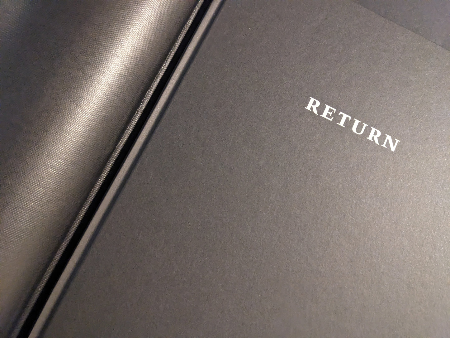 Close-up of the black cover with the title “RETURN” on Return by Larry Clark.