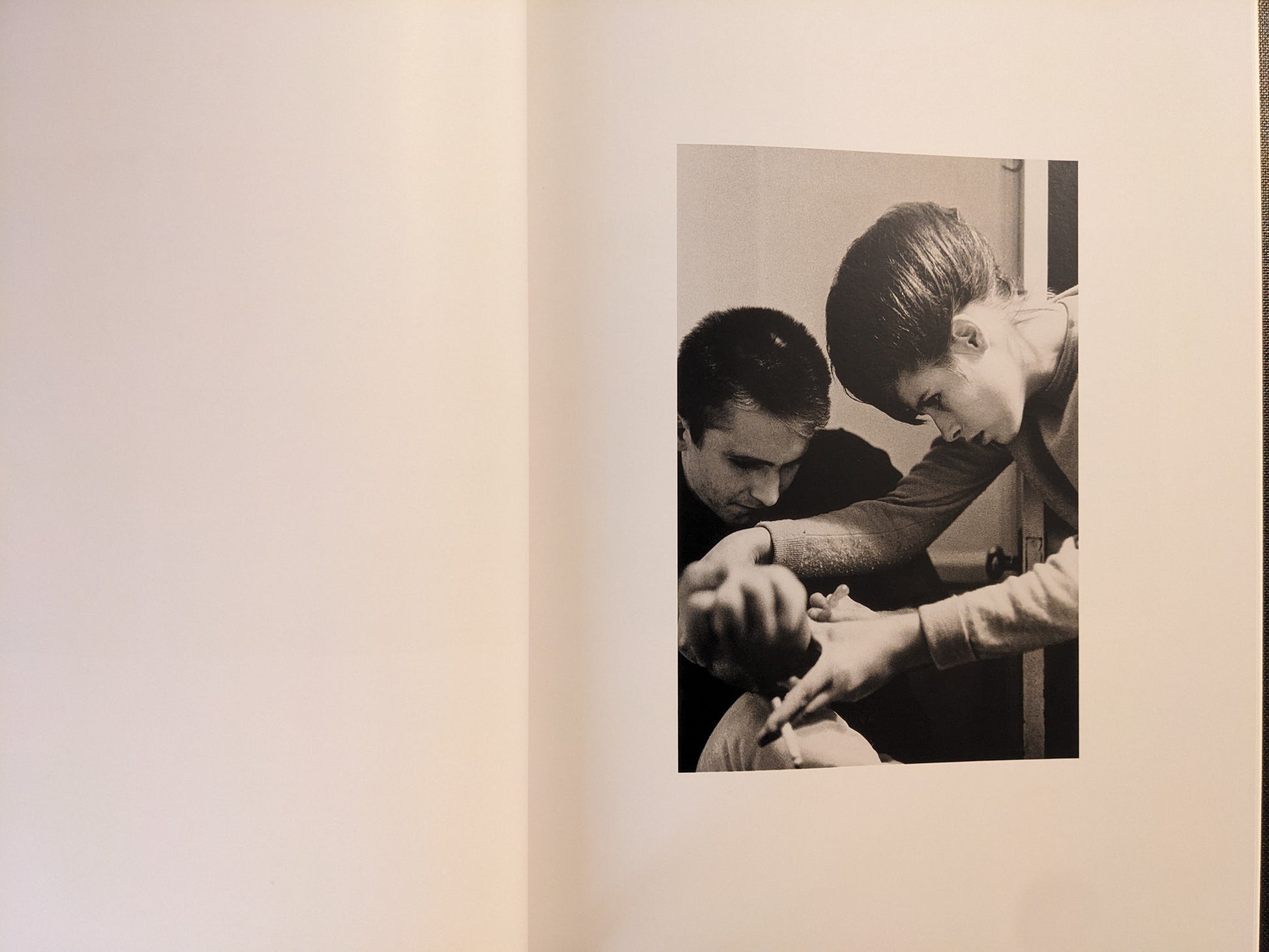Interior spread showing two people in close-up, with a syringe visible, black-and-white photograph.