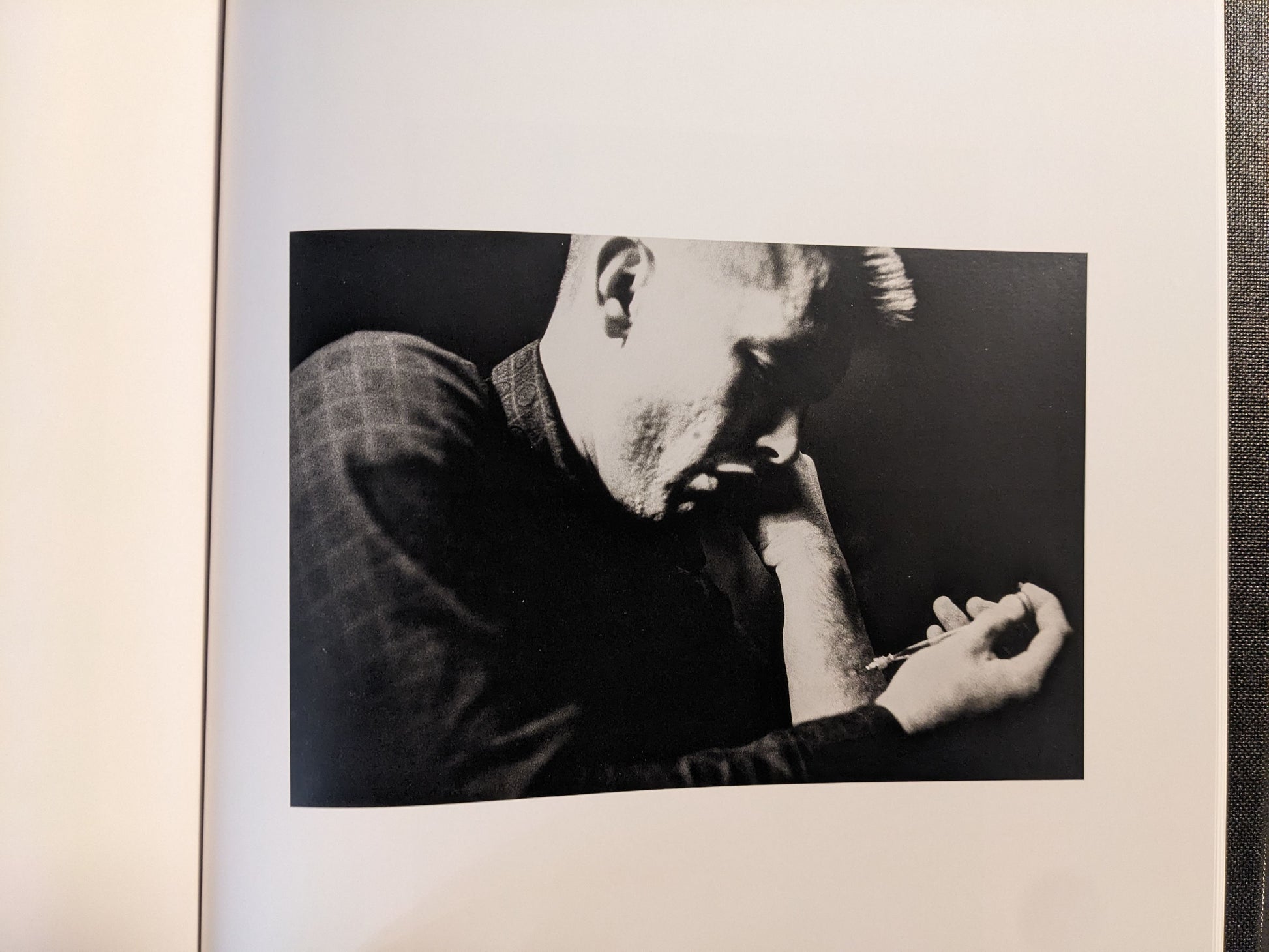Interior spread showing a black-and-white portrait with an arm close-up and a syringe visible.