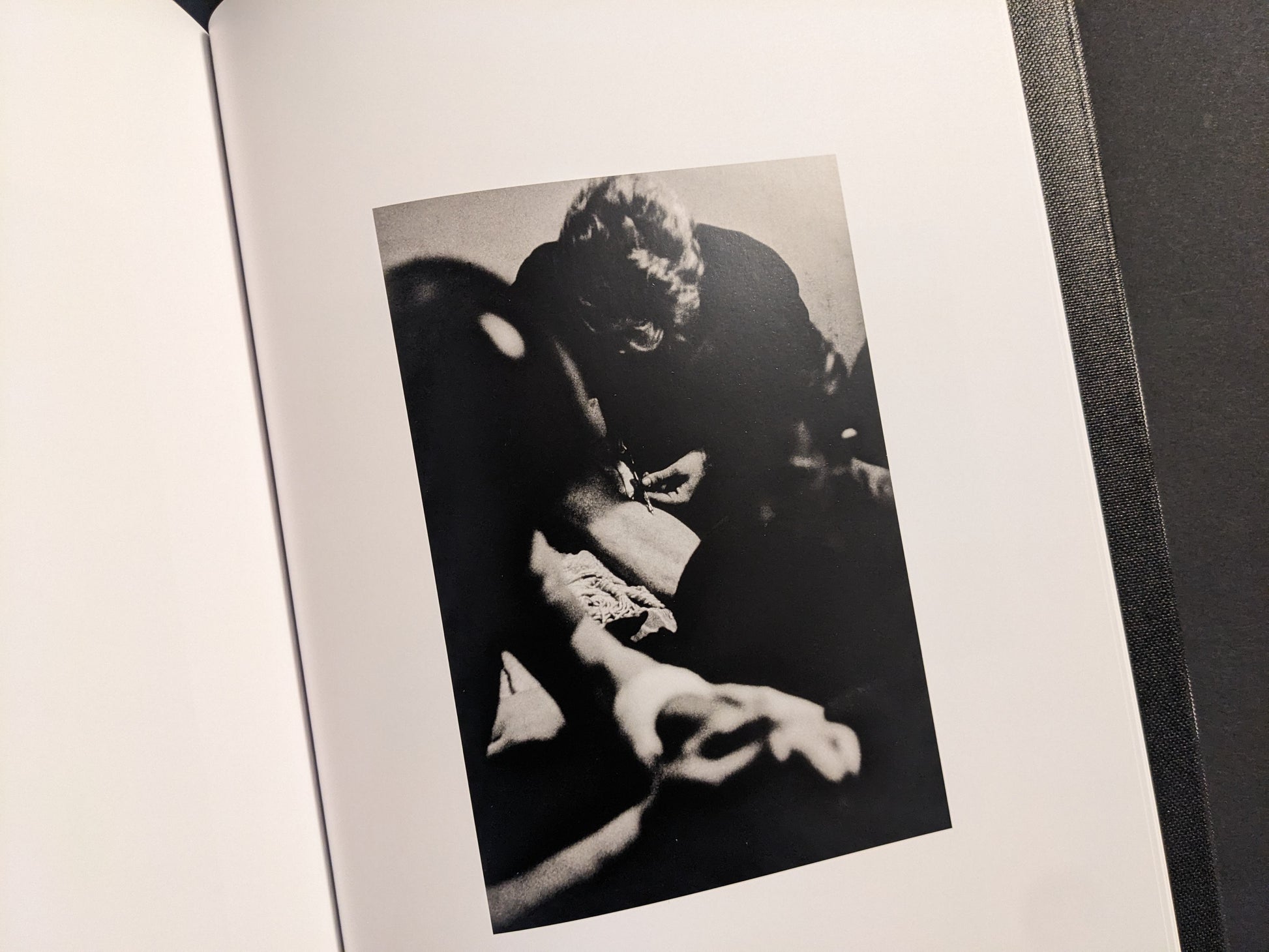Interior spread showing a vertical black-and-white photograph with an arm close-up and a syringe visible.