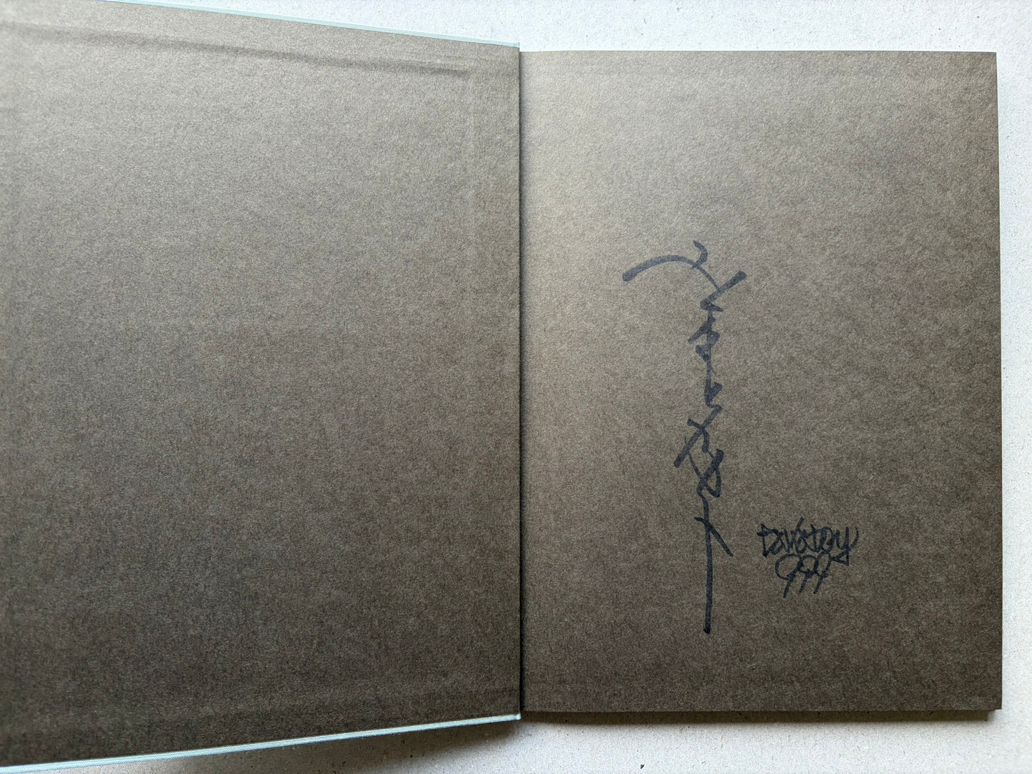 Rib of a Hermaphrodite by Takato Yamamoto, signed endpaper spread with handwritten signature on the right page.