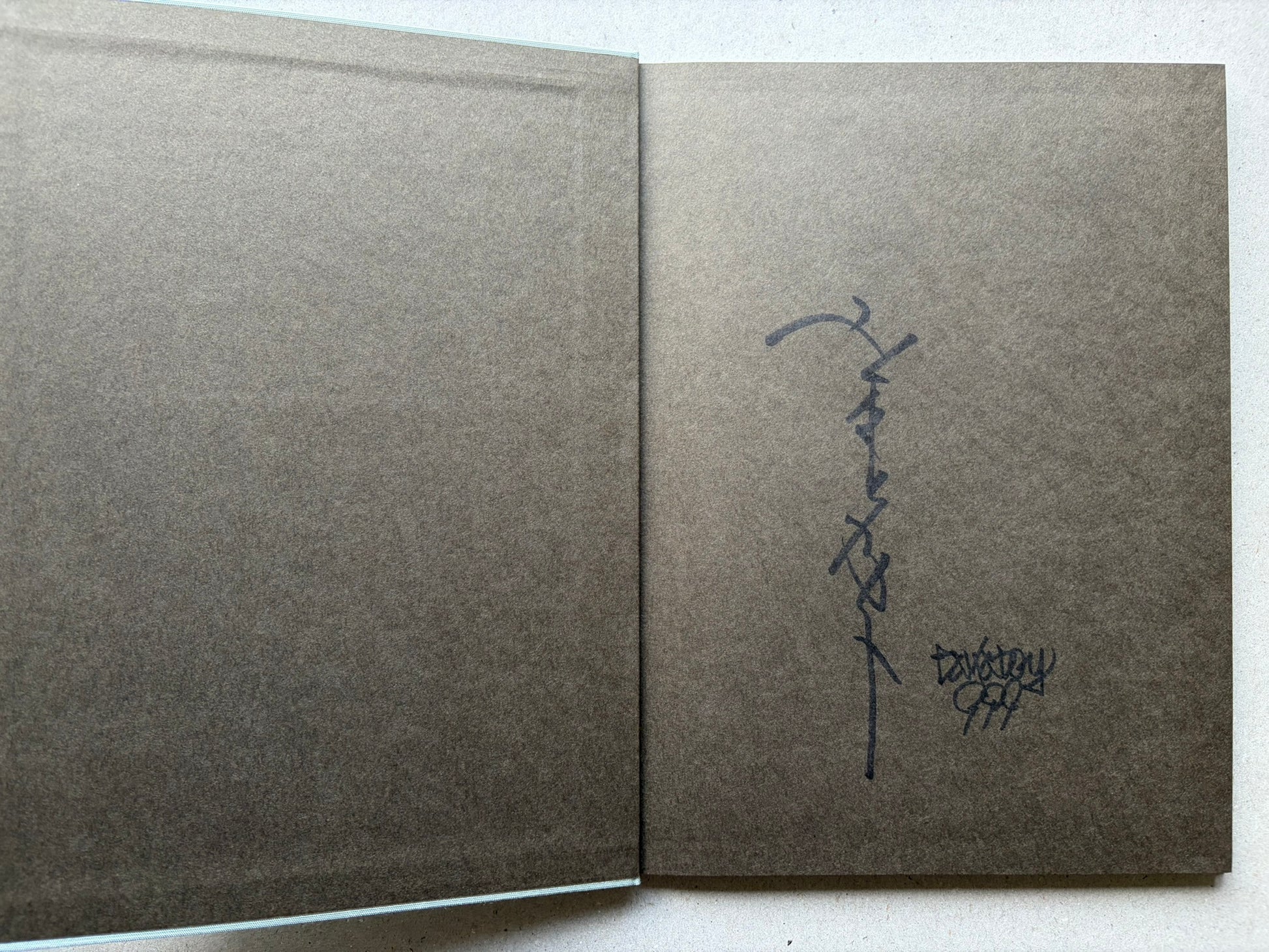 Rib of a Hermaphrodite by Takato Yamamoto, signed endpaper spread with handwritten signature on the right page.