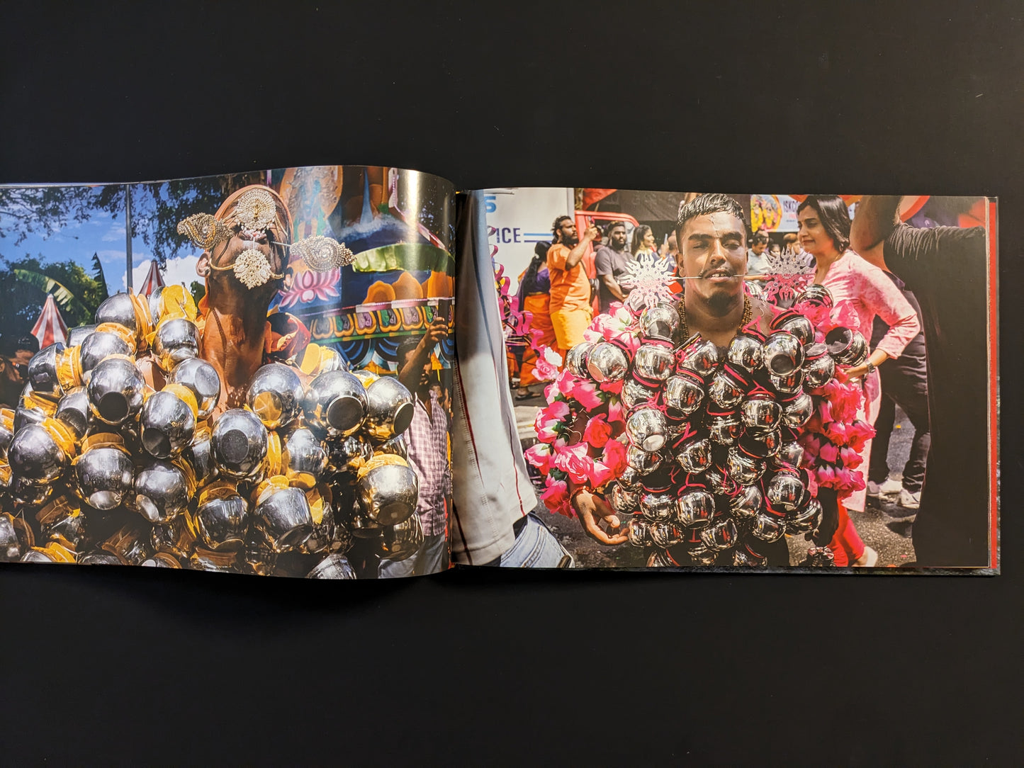 Thaipusam devotees carrying metallic offerings attached to their bodies.
