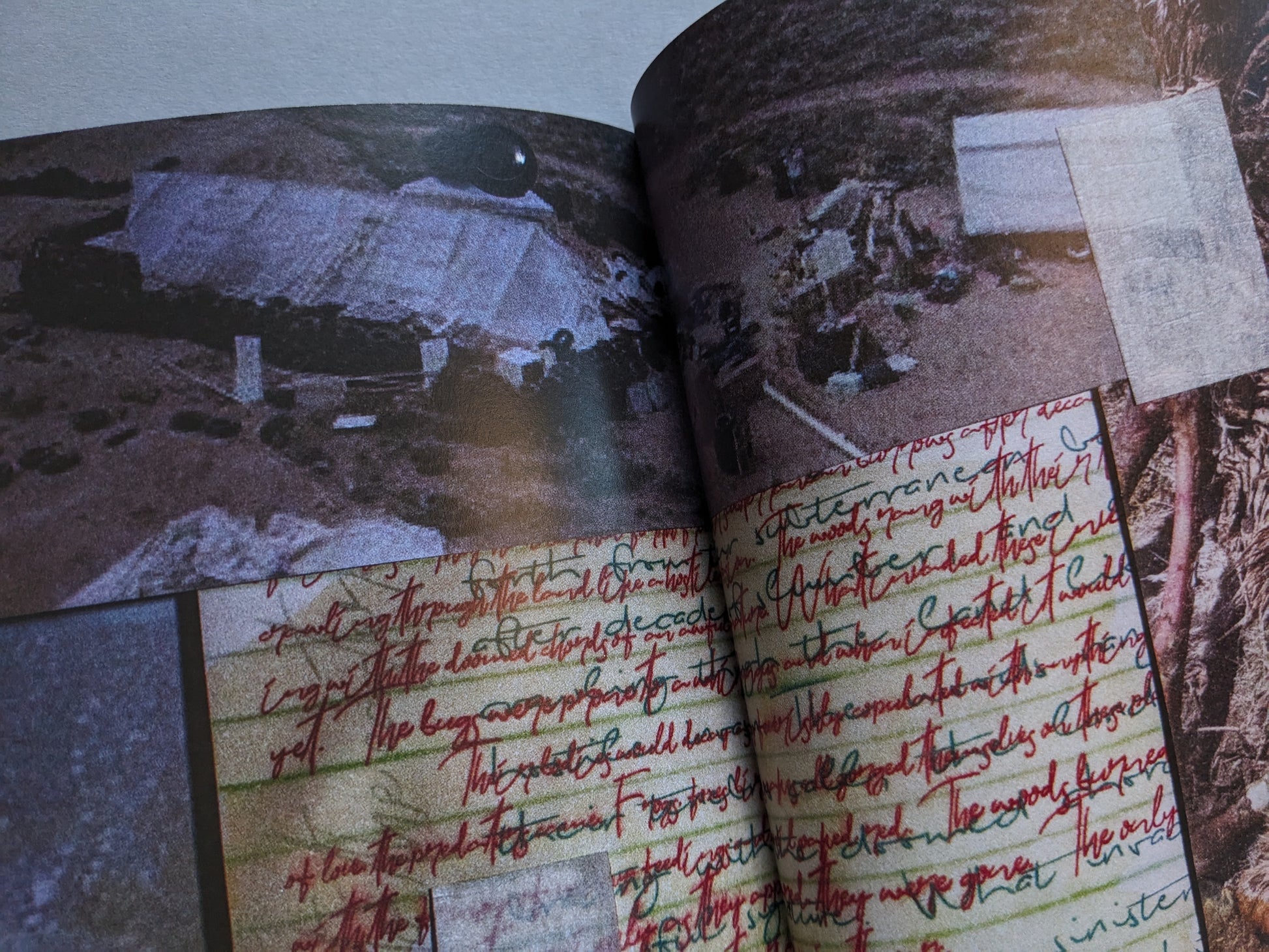 Double-page collage with handwritten red text over notebook paper and an aerial photograph of desert structures
