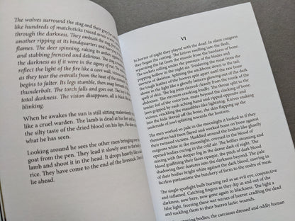 Spread from Sacra showing prose about wolves devouring a stag and a description of corpse preparation.