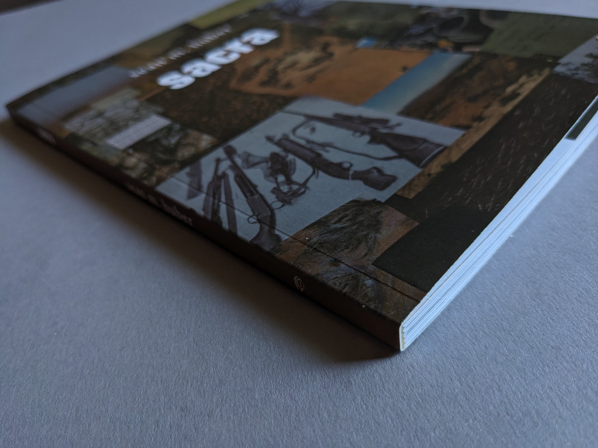 Spine view of "Sacra" showing the book's title and publisher