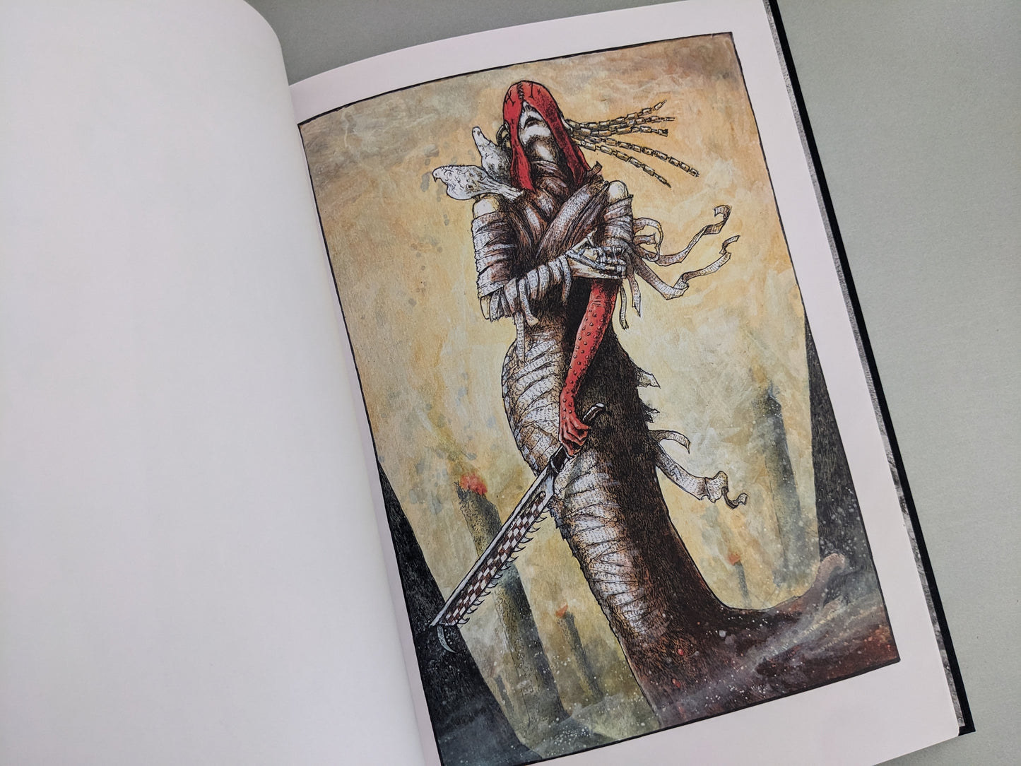 Wrapped warrior figure holding a sword