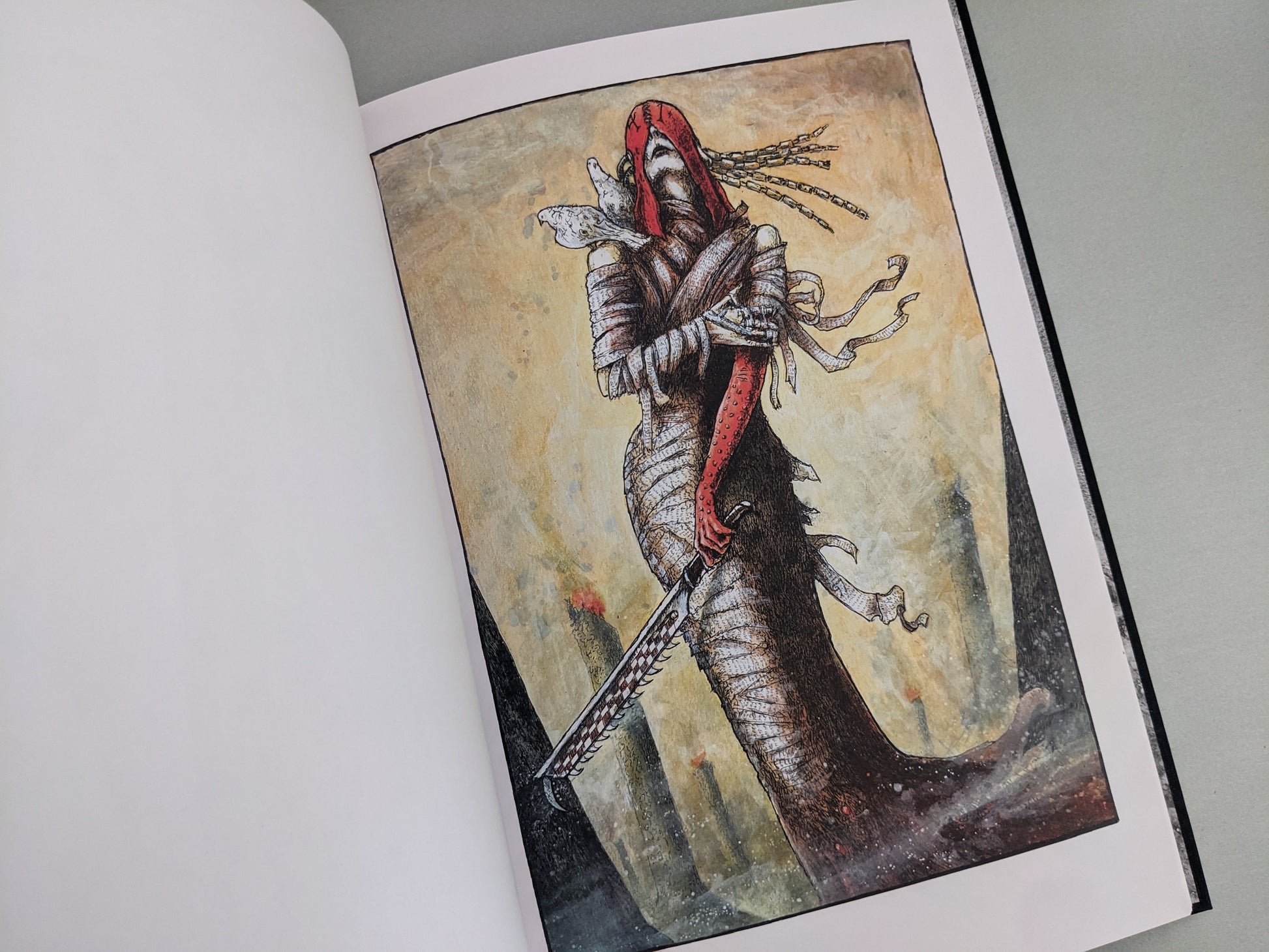 Wrapped warrior figure holding a sword