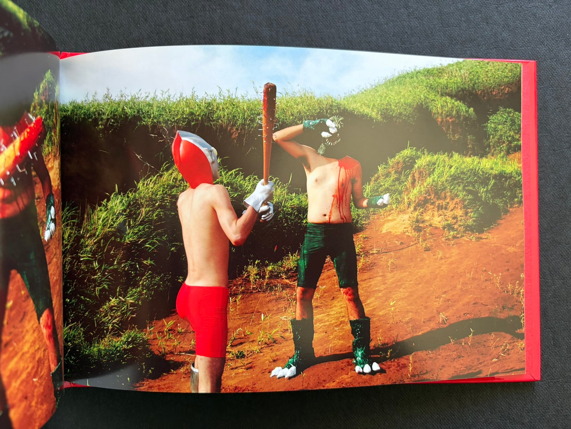 Open photobook spread from SEKAINOHEIWA by Daisuke Matsumoto