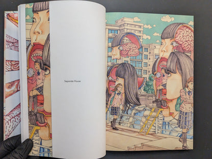 Interior spread: city scene with schoolgirls and open head motifs; caption “Separate House.”