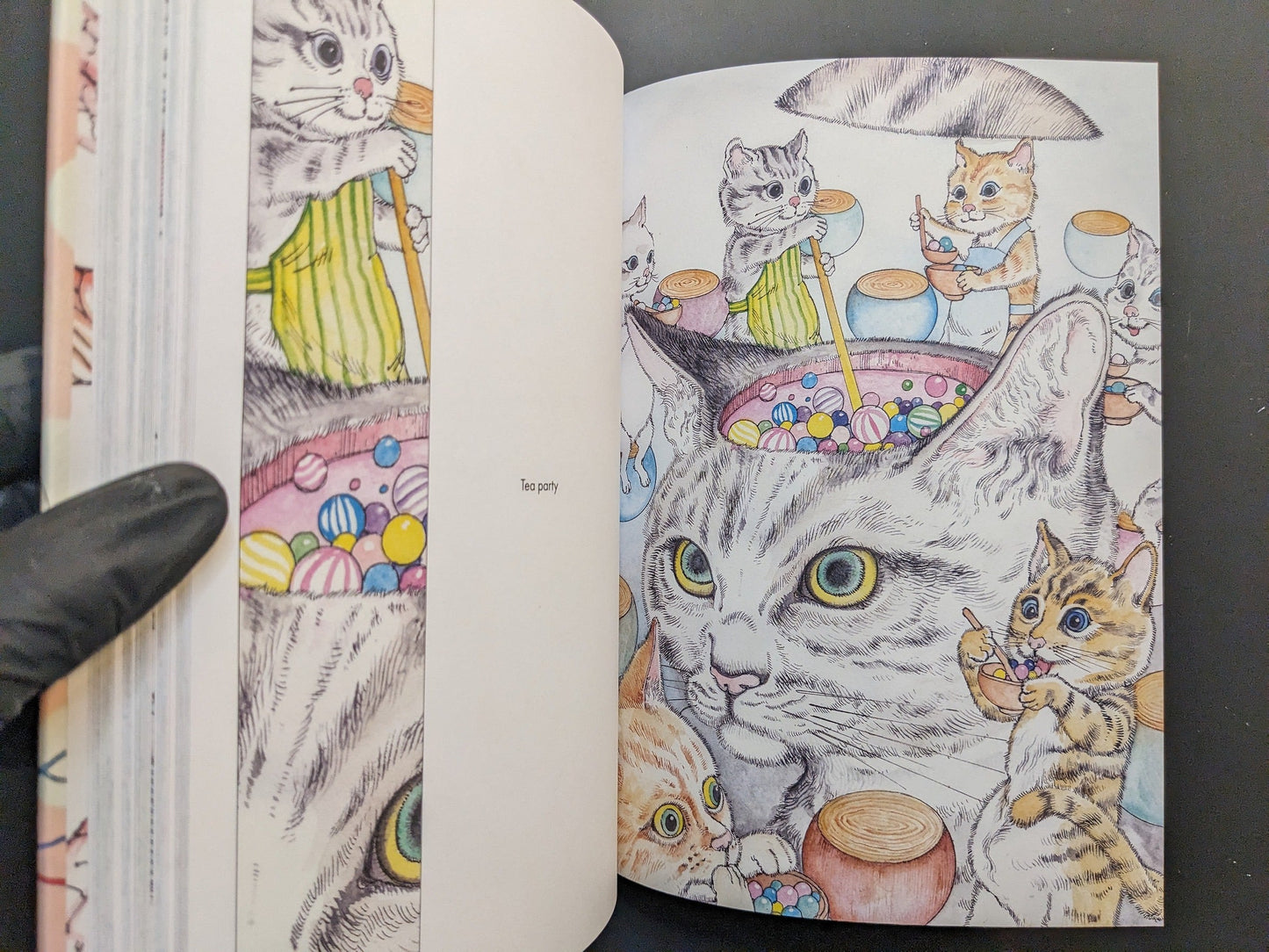 Interior spread titled “Tea party” showing whimsical cats around sweets and toys.