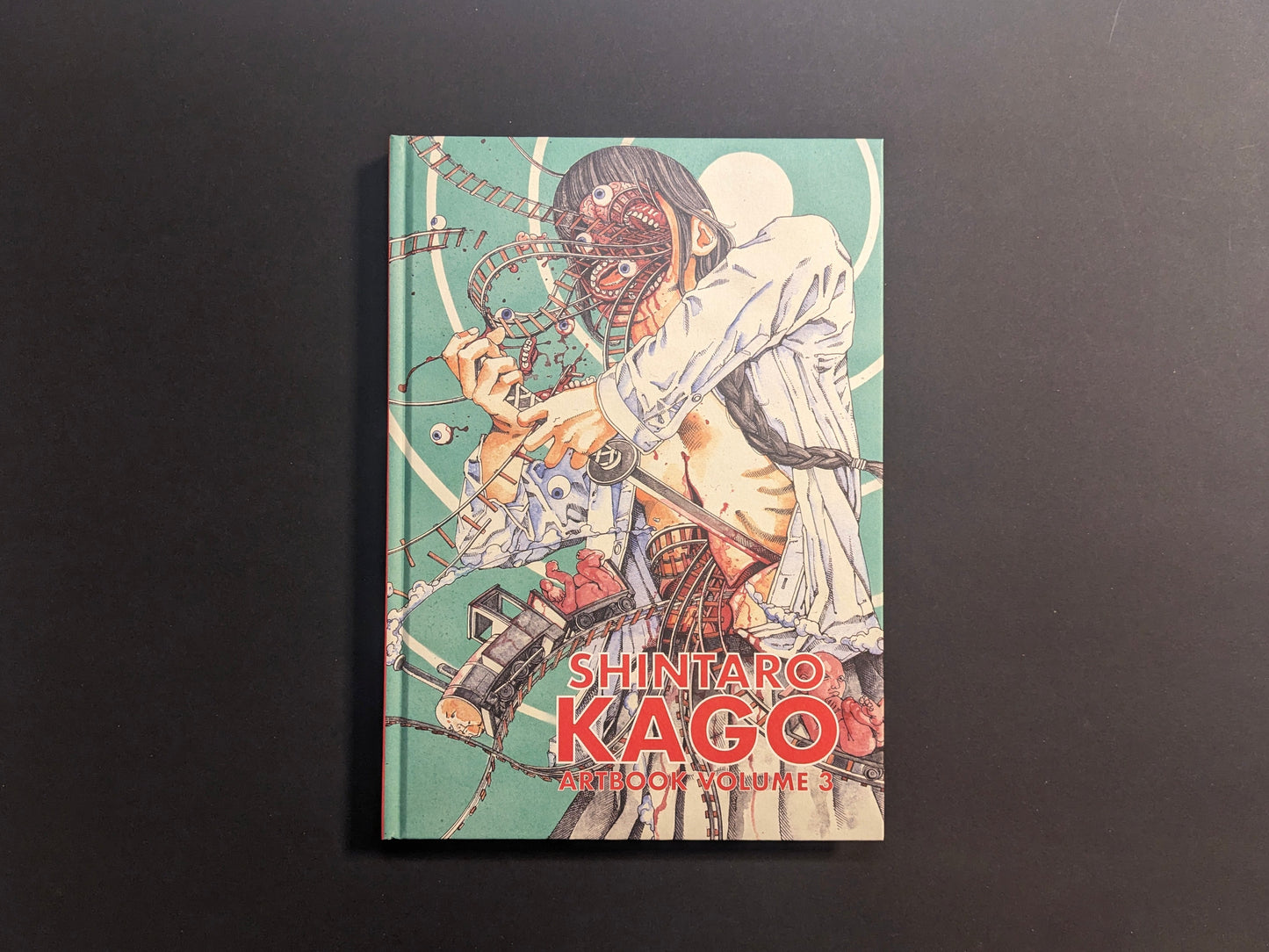 Front cover of Shintaro Kago Artbook Vol. 3 with a surgeon figure, rollercoaster tracks, and anatomical motifs.