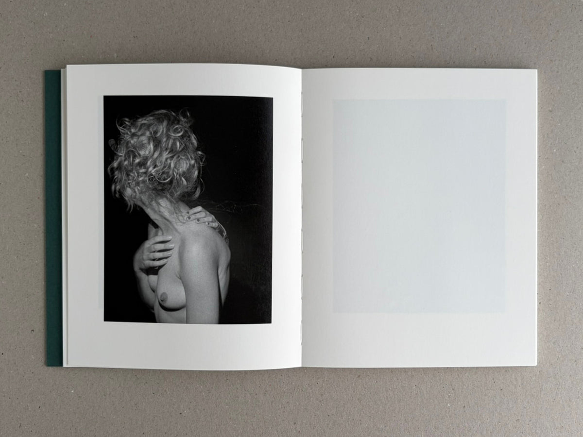 Open spread of Sleep Creek by Dylan Hausthor and Pia Paulina Guilmoth, with a black-and-white portrait on the left page and a blank pale page on the right.