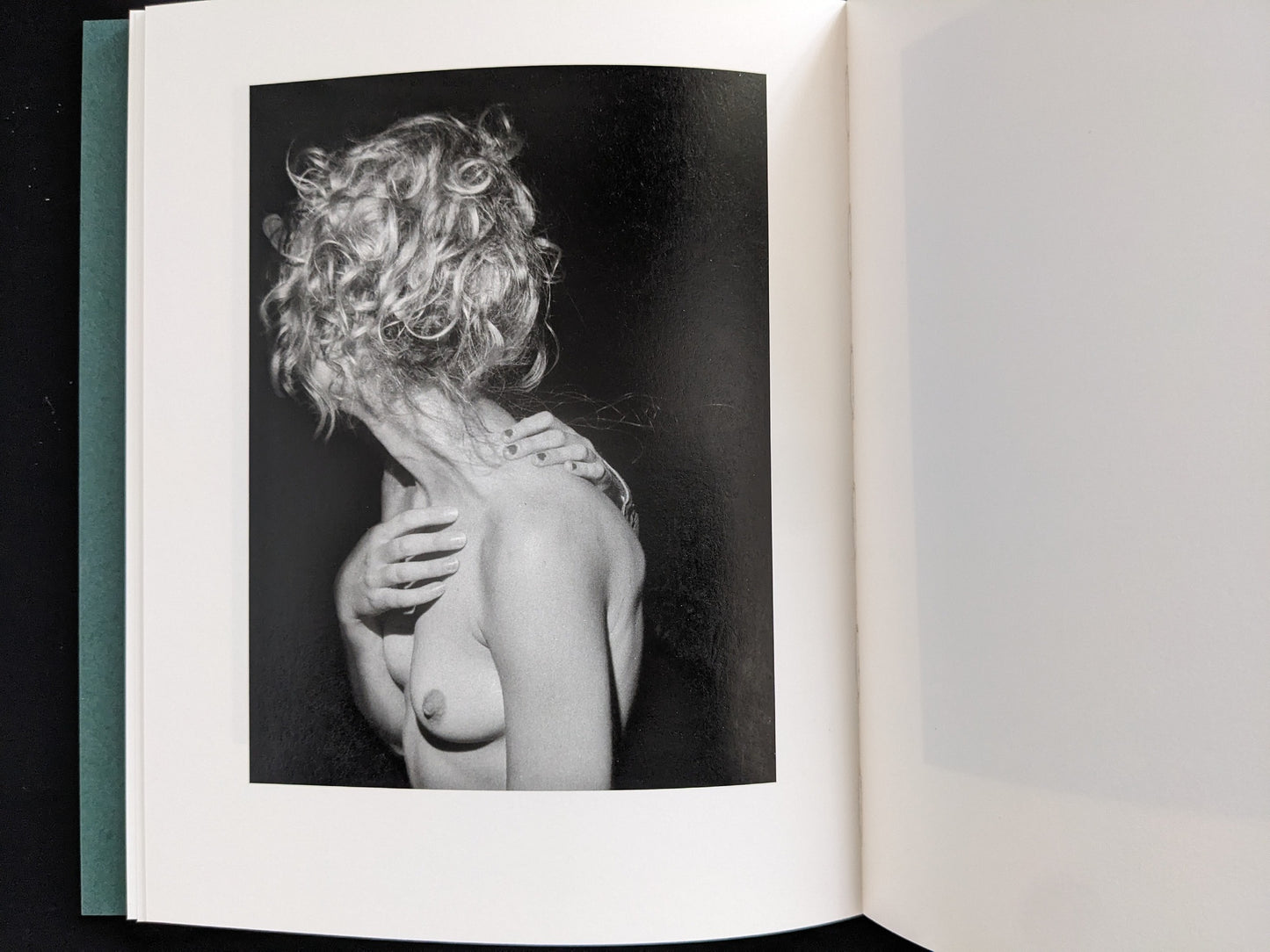Black-and-white photograph of a woman with curly hair turning away, bare torso and hand on shoulder — from Sleep Creek by Dylan Hausthor & Pia Paulina Guilmoth (Void).