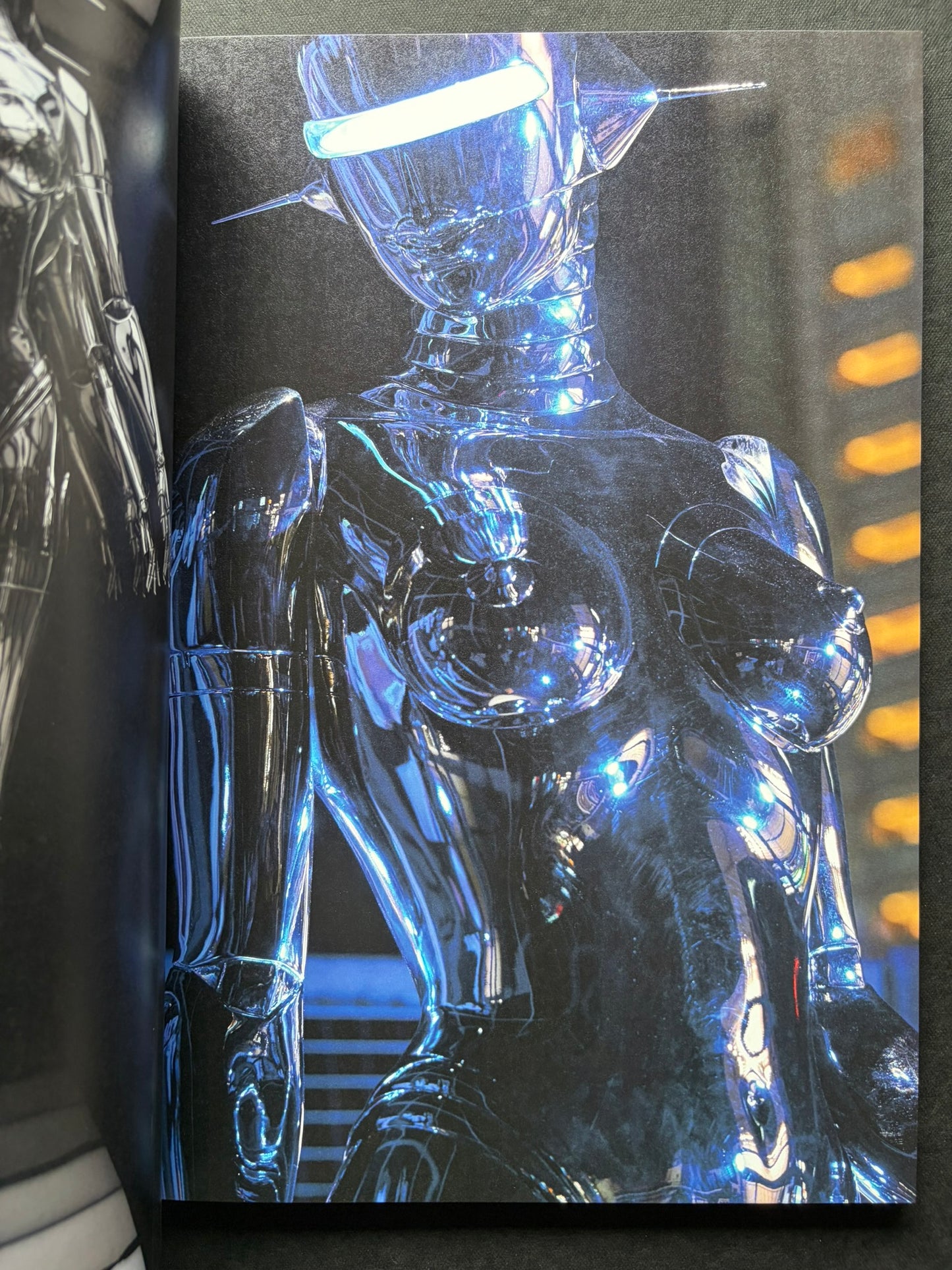 Interior spread of a blue-lit chrome gynoid figure in SORAYAMA: THE GYNOIDS SUBLIME.