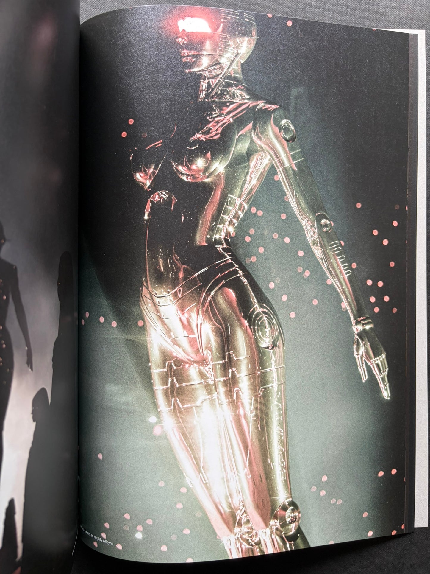 Interior spread of a reflective chrome gynoid figure on a dark background in SORAYAMA: THE GYNOIDS SUBLIME.