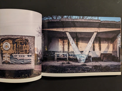 Interior spread: A-frame concrete bus shelter on left; emblematic wall mosaic with industrial and atomic motifs on right.