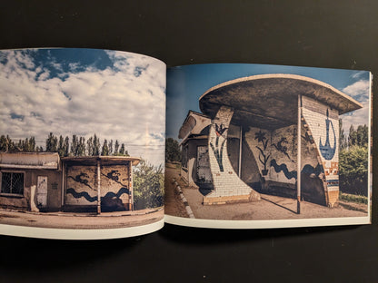 Interior spread: tiled bus shelters with curved walls and painted murals; weathered structures beside a rural road.