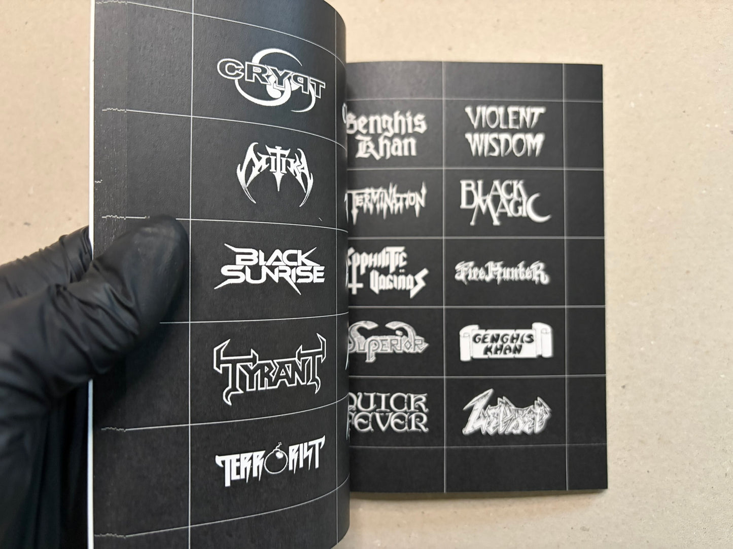Open spread of speed metal logos with varied white lettering on black pages